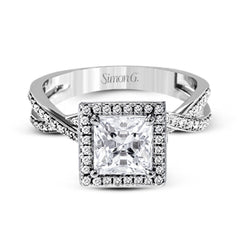This sparkling modern engagement ring features an eye-catching twisted design with elegant classic halo accented by .29 ctw of shimmering round cut white diamonds.