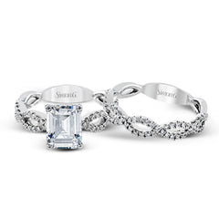 The intricate twisted design of this modern white gold engagement ring and wedding band set is set with .65 ctw of striking round cut white diamonds.