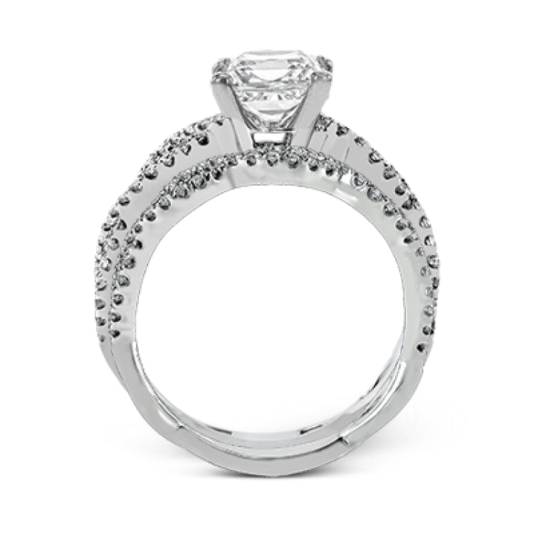 The intricate twisted design of this modern white gold engagement ring and wedding band set is set with .65 ctw of striking round cut white diamonds.