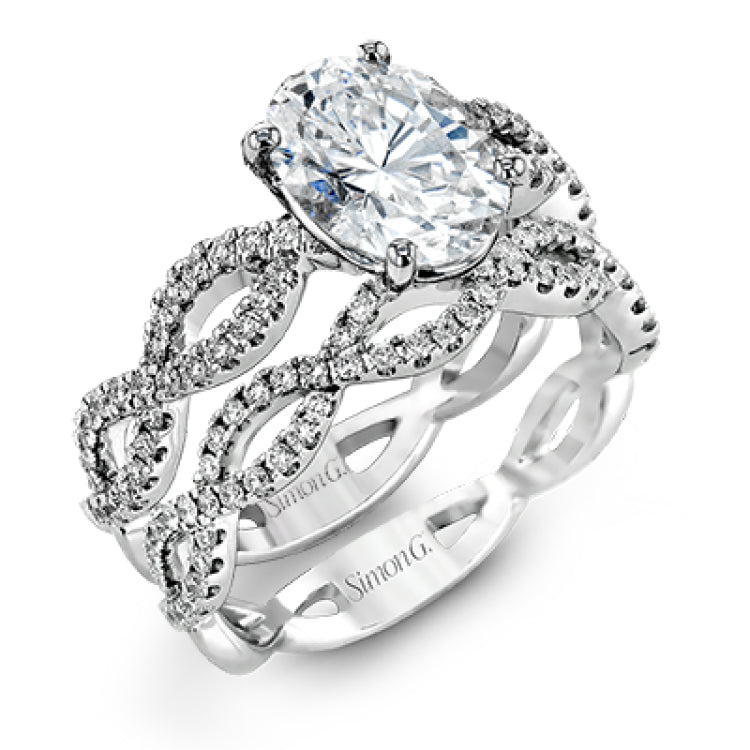 The intricate twisted design of this modern white gold engagement ring and wedding band set is set with .65 ctw of striking round cut white diamonds.