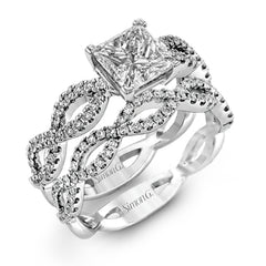 The intricate twisted design of this modern white gold engagement ring and wedding band set is set with .65 ctw of striking round cut white diamonds.