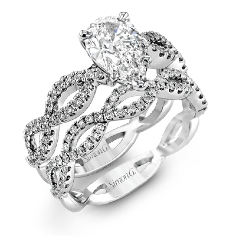 The intricate twisted design of this modern white gold engagement ring and wedding band set is set with .65 ctw of striking round cut white diamonds.