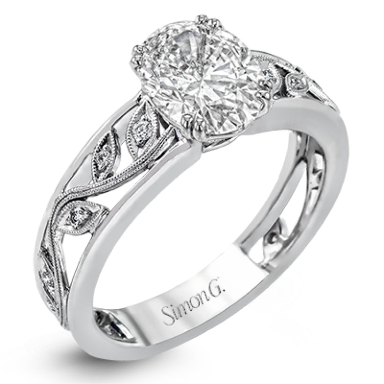 A delicate floral design highlights this vintage style engagement ring accented by .09 ctw of shimmering round cut white diamonds.