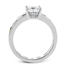 A delicate floral design highlights this vintage style engagement ring accented by .09 ctw of shimmering round cut white diamonds.