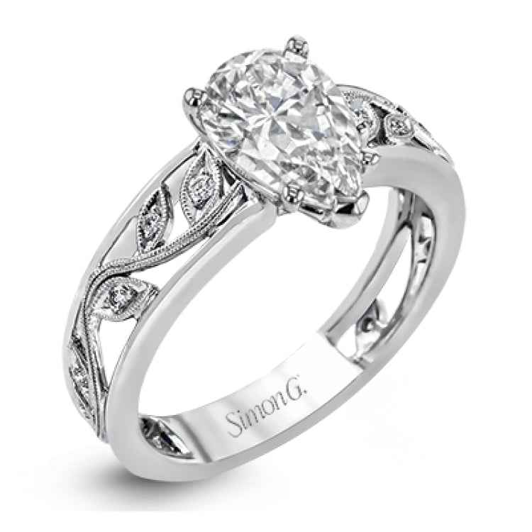 A delicate floral design highlights this vintage style engagement ring accented by .09 ctw of shimmering round cut white diamonds.