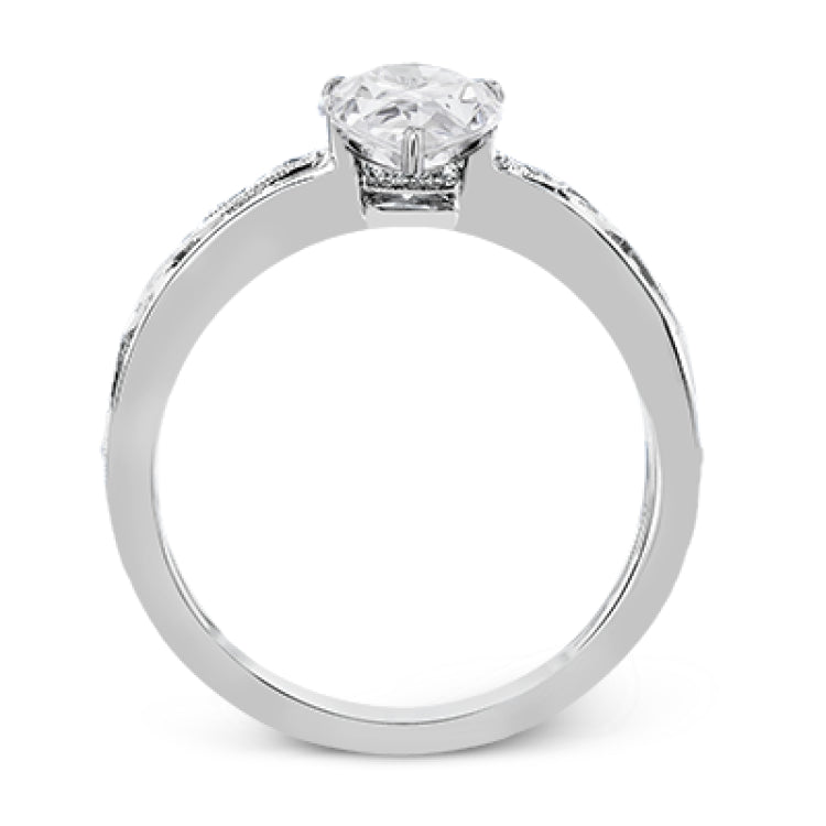 A delicate floral design highlights this vintage style engagement ring accented by .09 ctw of shimmering round cut white diamonds.
