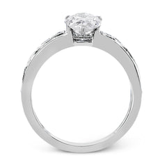 A delicate floral design highlights this vintage style engagement ring accented by .09 ctw of shimmering round cut white diamonds.