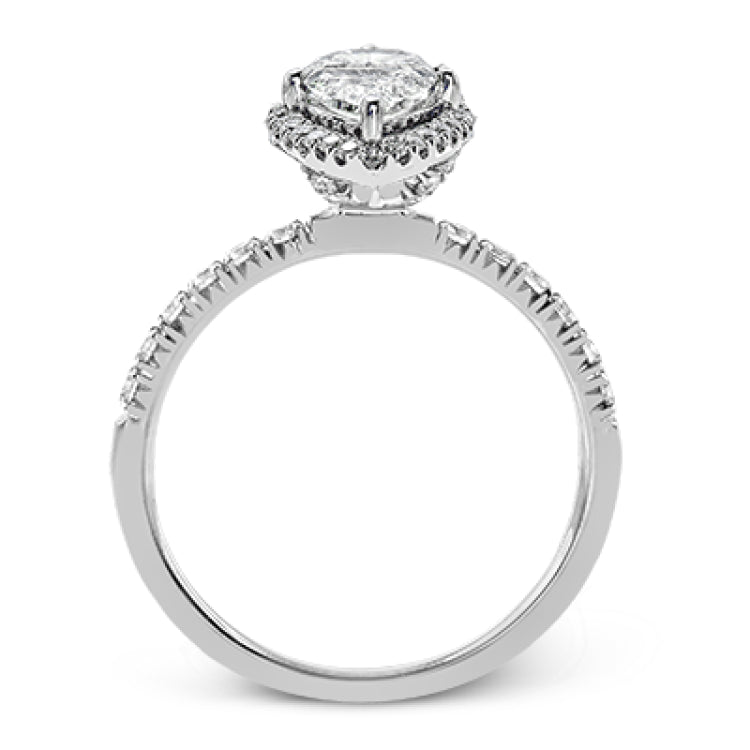This elegant classic white gold halo engagement ring and band is set with .78 ctw of sparkling round cut white diamonds.
