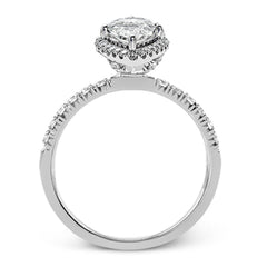 This elegant classic white gold halo engagement ring and band is set with .78 ctw of sparkling round cut white diamonds.