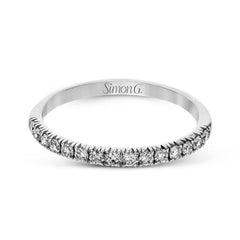 This elegant classic white gold halo engagement ring and band is set with .78 ctw of sparkling round cut white diamonds.