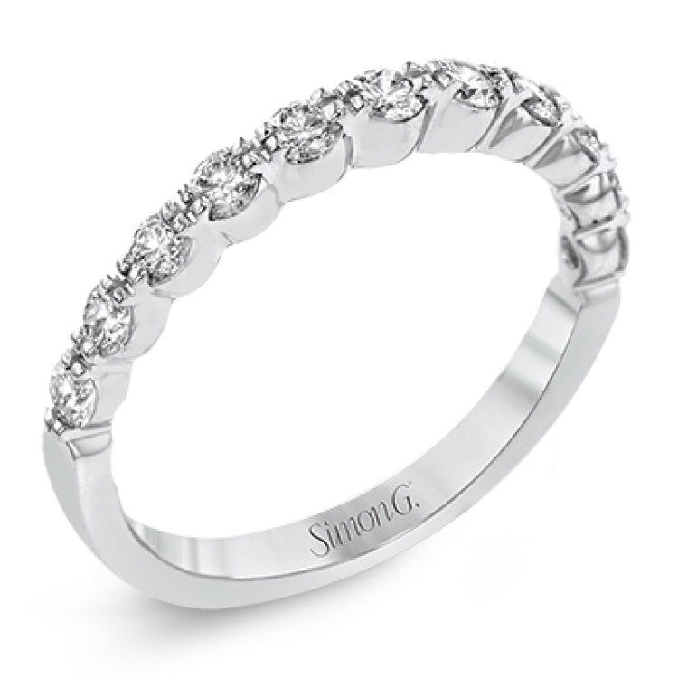 The delicate design of this classic white gold engagement ring features a sparkling pave halo accented with .86 ctw of shimmering round cut white diamonds.