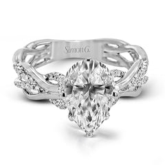 This impressive contemporary white engagement ring features a unique twisting design on the shank, which is complemented by .17 ctw of round cut white diamonds.