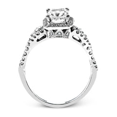 Reflecting an intricate modern design, this remarkable white gold ring is emphasized by a lovely halo complemented with .59 ctw round cut white diamonds.