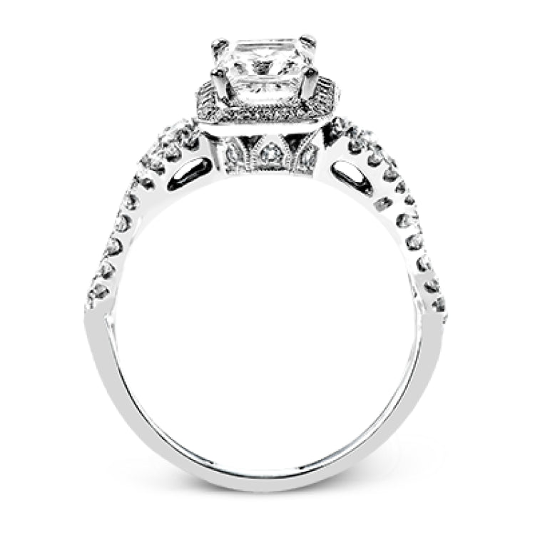 Reflecting an intricate modern design, this remarkable white gold ring is emphasized by a lovely halo complemented with .59 ctw round cut white diamonds.