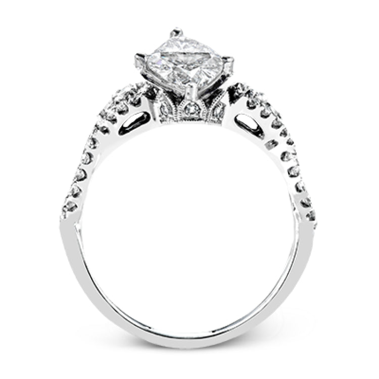 Reflecting an intricate modern design, this remarkable white gold ring is emphasized by a lovely halo complemented with .59 ctw round cut white diamonds.