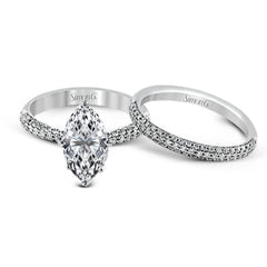 The classic design of this white gold engagement ring and wedding band set is emphasized by .72 ctw round cut white diamonds.