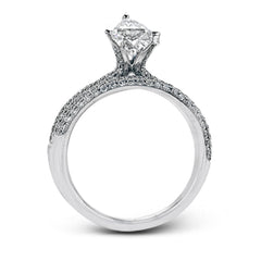 The classic design of this white gold engagement ring and wedding band set is emphasized by .72 ctw round cut white diamonds.