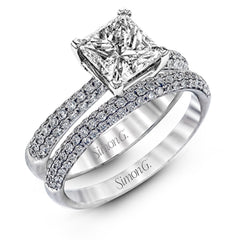 The classic design of this white gold engagement ring and wedding band set is emphasized by .72 ctw round cut white diamonds.
