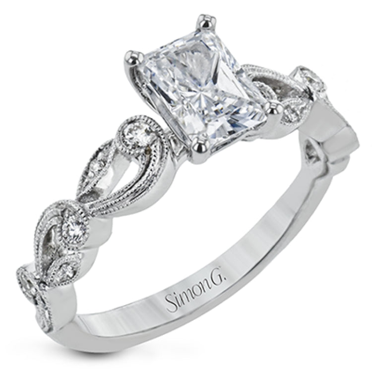 This delicate floral inspired white gold engagement ring and wedding band set is accentuated with .28 ctw shimmering round cut white diamonds.