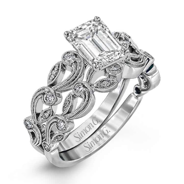 This delicate floral inspired white gold engagement ring and wedding band set is accentuated with .28 ctw shimmering round cut white diamonds.
