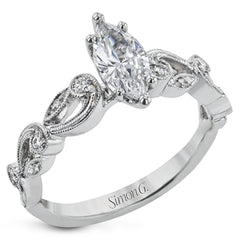 This delicate floral inspired white gold engagement ring and wedding band set is accentuated with .28 ctw shimmering round cut white diamonds.