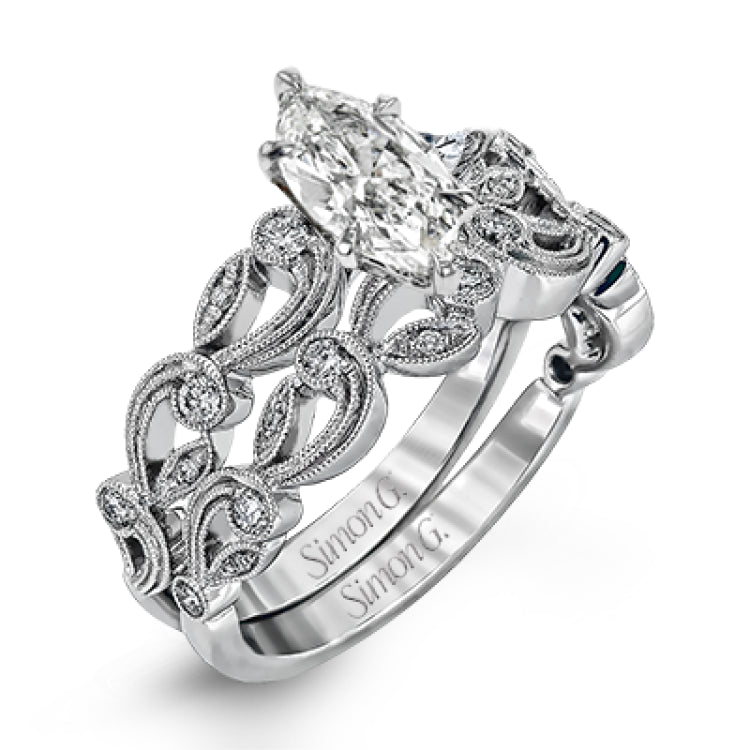 This delicate floral inspired white gold engagement ring and wedding band set is accentuated with .28 ctw shimmering round cut white diamonds.