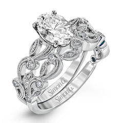 This beautiful vintage-inspired engagement ring design is built for an oval center stone and contains the perfect touches of .28 ctw of white diamonds in its midst.