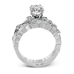 This beautiful vintage-inspired engagement ring design is built for an oval center stone and contains the perfect touches of .28 ctw of white diamonds in its midst.