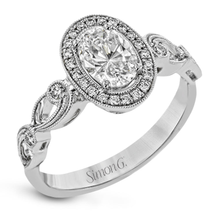 Reflecting a lovely romantic design, this white gold classic engagement ring features .16 ctw round cut white diamond accents.