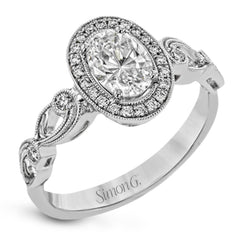 Reflecting a lovely romantic design, this white gold classic engagement ring features .16 ctw round cut white diamond accents.
