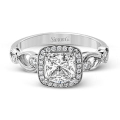 Reflecting a lovely romantic design, this white gold classic engagement ring features .16 ctw round cut white diamond accents.