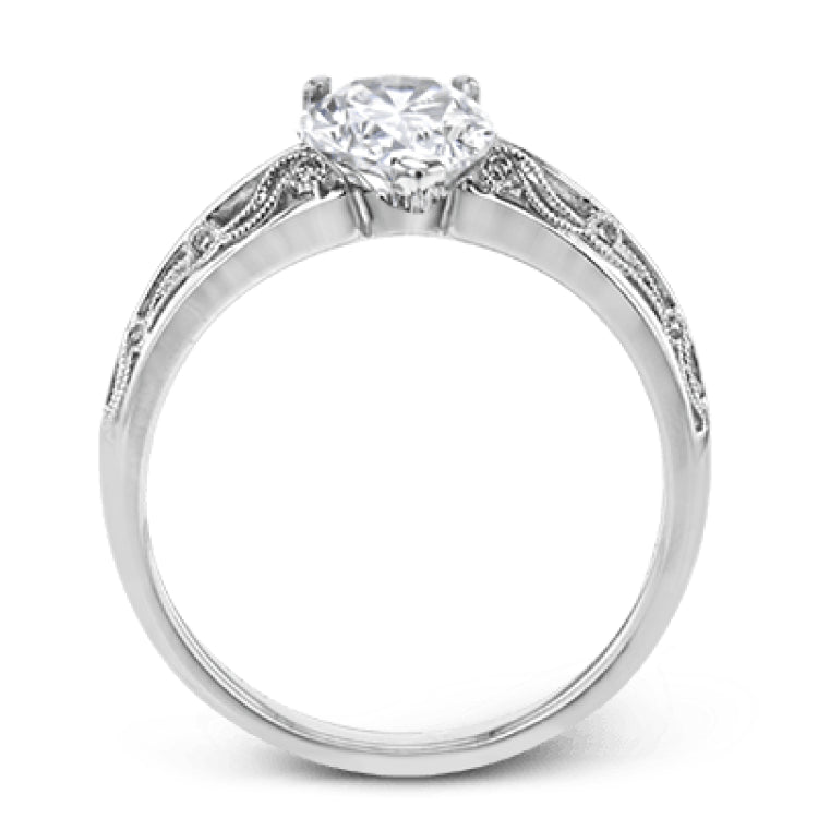 A whimsical openwork design glimmers with .04 ctw of round white diamonds in this charmingly beautiful white gold engagement ring.