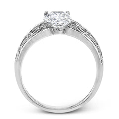 A whimsical openwork design glimmers with .04 ctw of round white diamonds in this charmingly beautiful white gold engagement ring.
