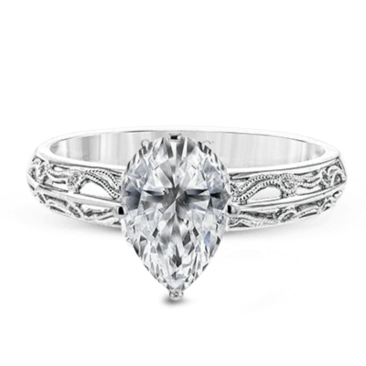 A whimsical openwork design glimmers with .04 ctw of round white diamonds in this charmingly beautiful white gold engagement ring.