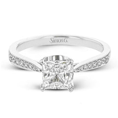 The delicate, understated design of this lovely white gold ring is elevated by .27 ctw of round white diamond accents.