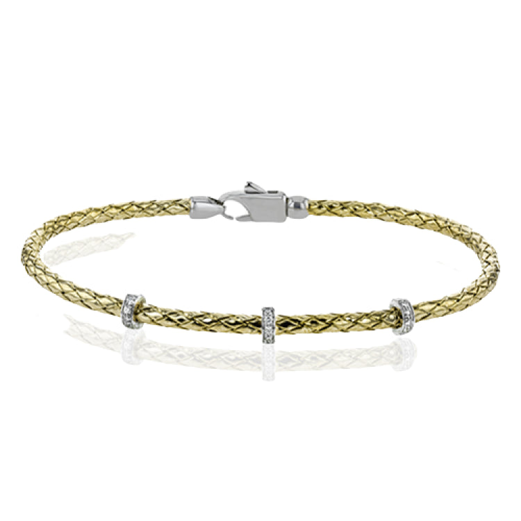 This easy-to-wear bracelet features three white gold stations set with .10ctw of diamonds set in a woven braid of 18k yellow gold.