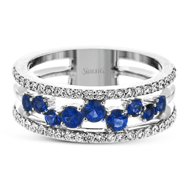 This ring features a meandering path of .65 ctw offset sapphires in it midst, flanked by .38 ctw white diamonds along the edges.