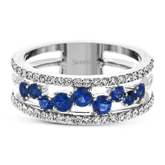 This ring features a meandering path of .65 ctw offset sapphires in it midst, flanked by .38 ctw white diamonds along the edges.