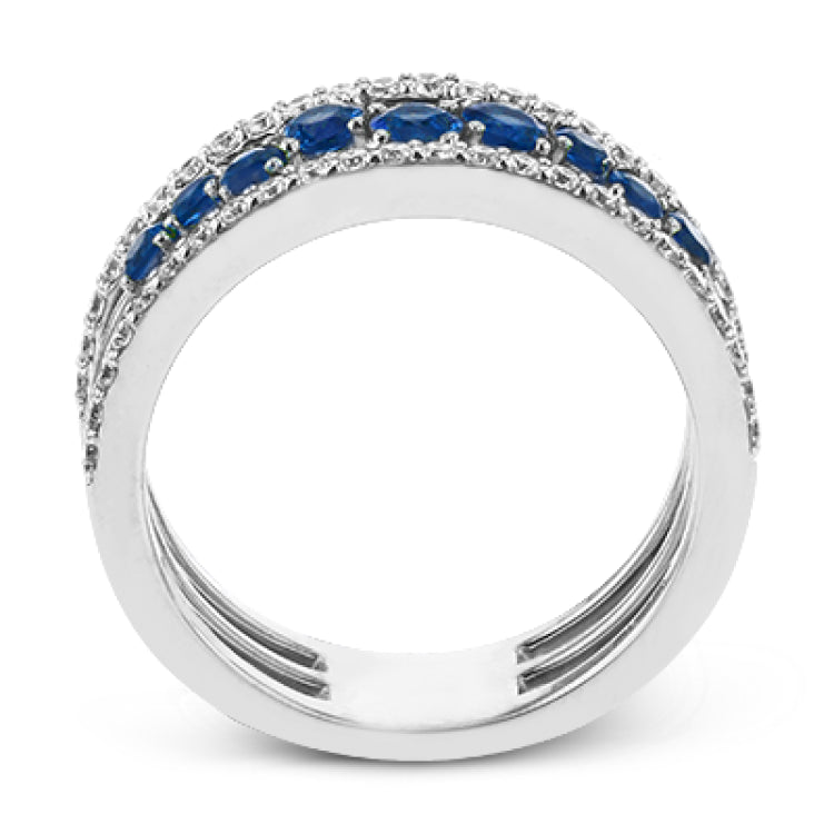 This ring features a meandering path of .65 ctw offset sapphires in it midst, flanked by .38 ctw white diamonds along the edges.