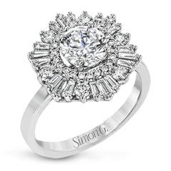Crafted from 18k gold, this halo ring features a stunning .36 ctw of round diamonds and .49 ctw of baguette shaped diamonds.