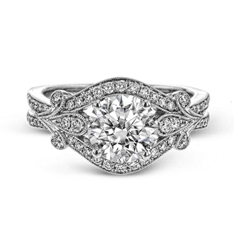 This absolutely exquisite white gold engagement ring dazzles the eye with .38 ctw of round white diamonds in a glamorous, vintage-inspired setting.