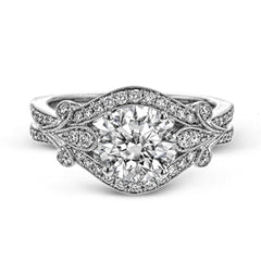 This absolutely exquisite white gold engagement ring dazzles the eye with .38 ctw of round white diamonds in a glamorous, vintage-inspired setting.