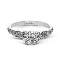 This remarkable white gold ring features .18 ctw of round white diamonds and delicate milgrain edging for a sleek, romantic look.