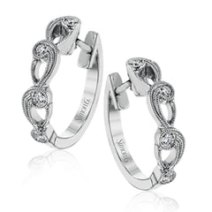 These beautiful white gold earrings feature an intricate scrolling design with .11 ctw of round white diamonds for just a hint of sparkle.