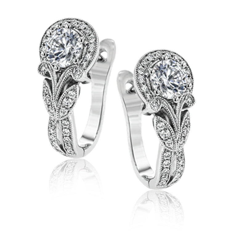 Magnificently glamorous, these white gold earrings feature delicate milgrain edging along with .21 ctw of round white diamond accents.