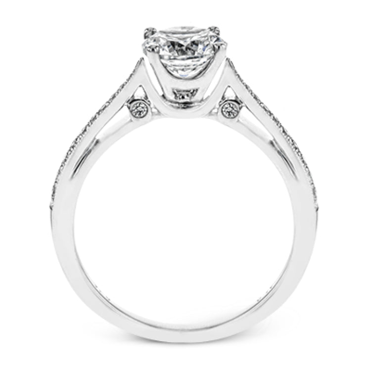 Sleek and lovely, this white gold engagement ring has an elegant design enhanced with .14 ctw of round white diamonds.