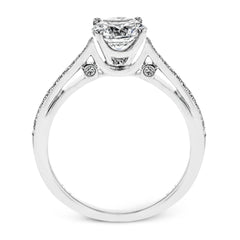 Sleek and lovely, this white gold engagement ring has an elegant design enhanced with .14 ctw of round white diamonds.