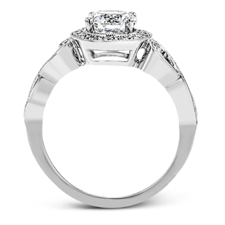 This remarkably beautiful white gold ring features intricate milgrain details alongside a lovely halo of .06 ctw of round white diamonds.
