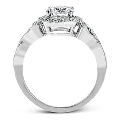 This remarkably beautiful white gold ring features intricate milgrain details alongside a lovely halo of .06 ctw of round white diamonds.
