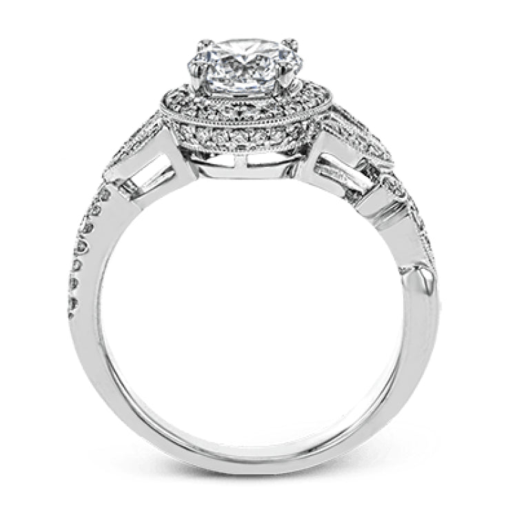 The stunning nature-inspired design of this white gold engagement ring features lovely milgrain edging and a total of .34 ctw of round white diamond accents.